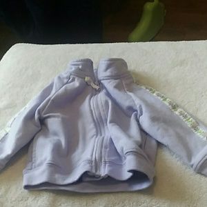 A lavender jacket with ribbon stripe on sleeve.